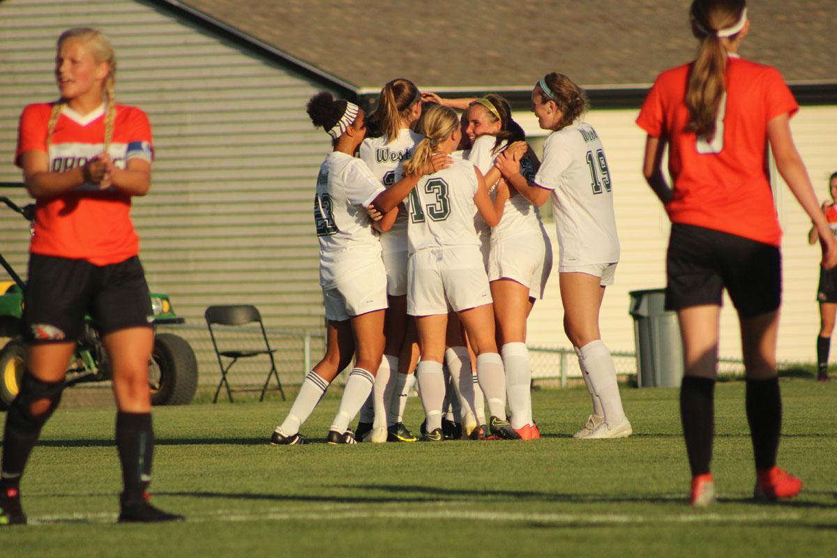 The team hugs Lexi Shaffer '17 after she scored the second goal of the game during the second half of the game. 