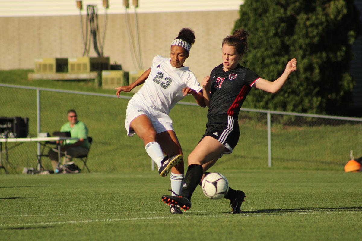 Leah Rhodes '17 kicks the ball past Clinton player Allison Mitchell '19. 