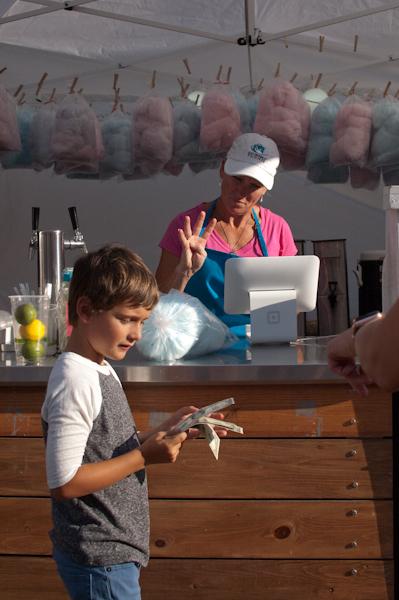 A young boy buys cotton candy at a concession stand at the Iowa City Jazz Festival on July 2. 
