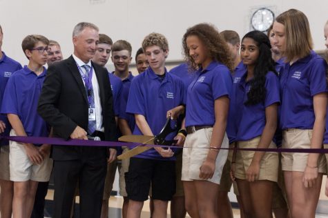 The Student Advisory Group, students tasked with designing parts of Liberty, picking a mascot, and giving tours, cut the ceremonial ribbon with principal Scott Kibby for Liberty Highs opening on Aug. 12.
