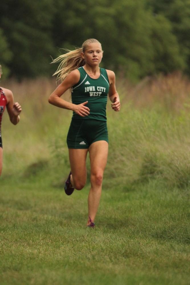 Colleen Bloser '18 runs past the second mile mark. She placed second in the varsity race with a time of 19:50.