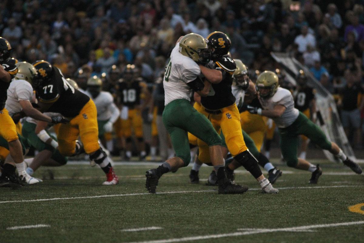 Dillion Shephard '18 blocks a player from Southeast Polk during the first quarter on Friday, Aug. 25. 