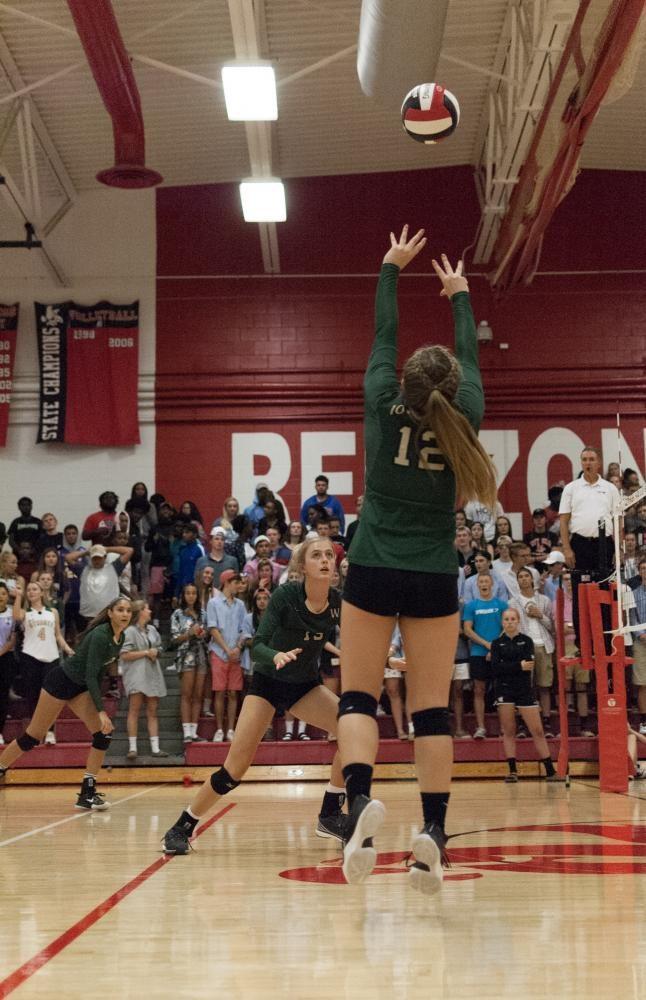 Katie Severt 19 sets the ball for Claire Overton 19 in the third set of the game against City on Sept. 5.