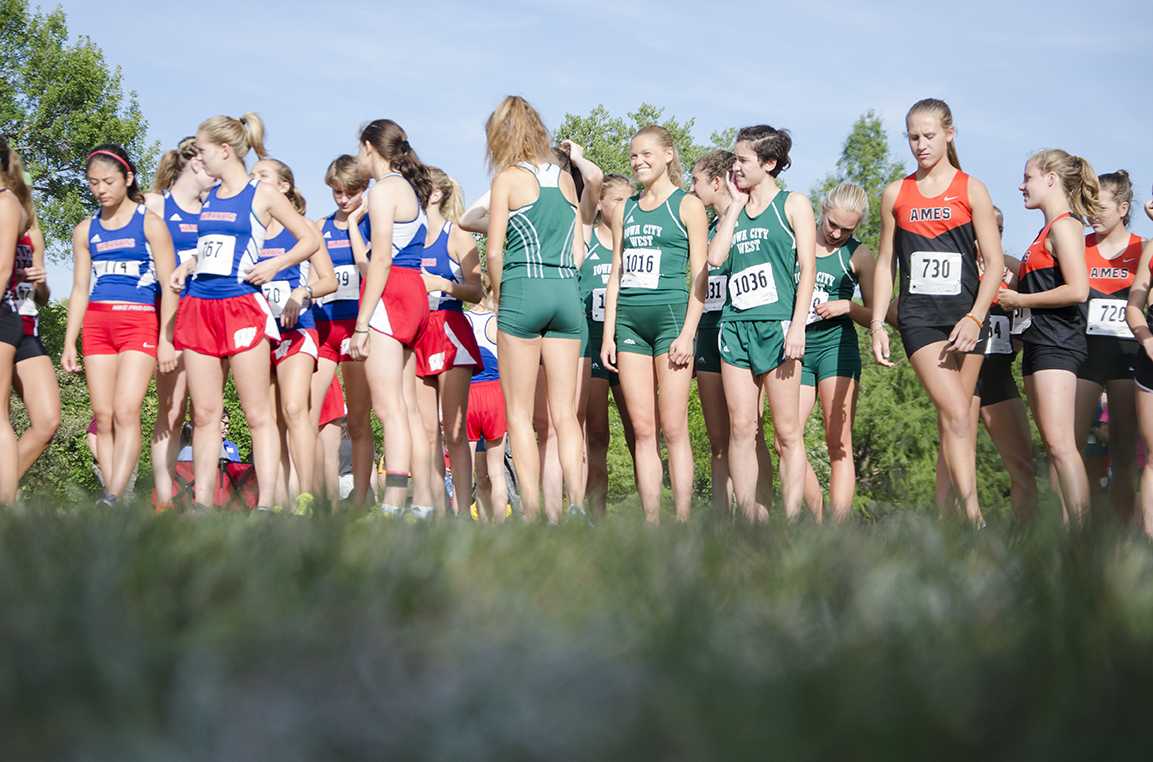 The girls varsity cross country team stands in place before their race at Noelridge Park on Sept. 7.