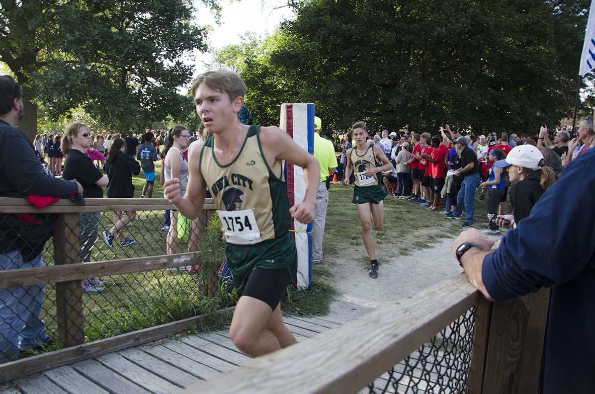 Issac Miller 18 and Micah Bailey 18 run in the Cedar Rapids Invite at Noelridge Park on Sept. 7. 