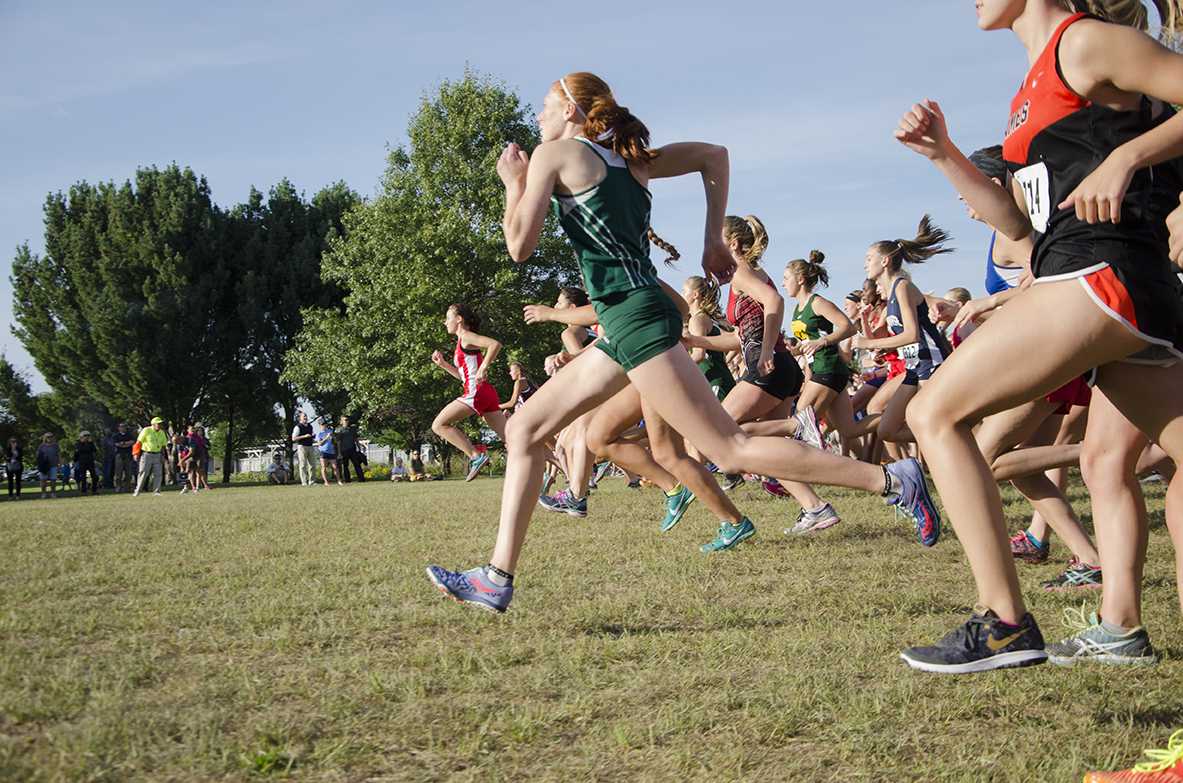 Claire Ronnebaum 18 begins to break away from the pack at the beginning of the JV race for the Cedar Rapids Invite at Noelridge Park on Sept. 7. 