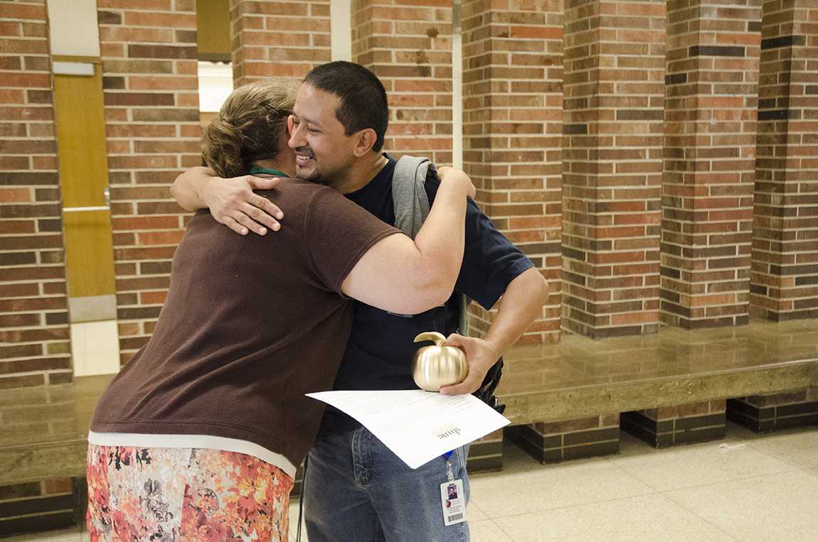 Math teacher Jean Morsch congratulates Carlos with a hug after the ceremony on Sept. 13 in the main commons. 