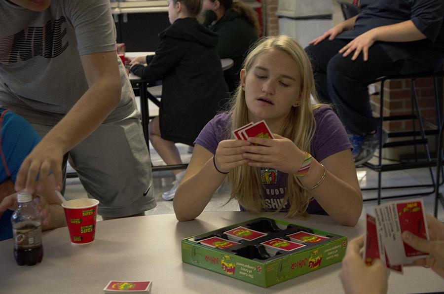 Laurel Haverkamp 20 studies her cards during a round of Apples to Apples at the Best Buddies ice cream social.