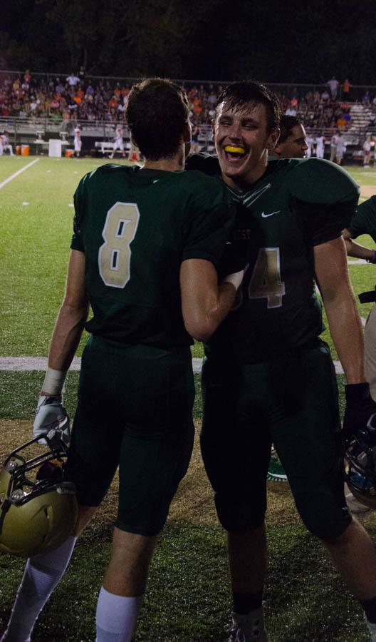 Austin Geasland 18 and Joe Briddle 18 embrace on the sideline after an important offensive play.