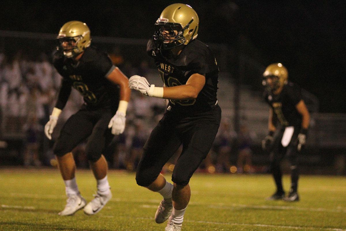 Cole Mabry '19 gets ready to block a player from Muscatine on Friday, Sep. 1.