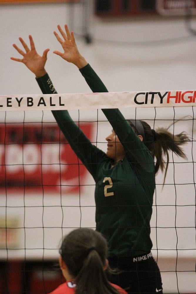 Cailyn Morgan '19 jumps up to try to block the ball on Tuesday, Sept. 5.