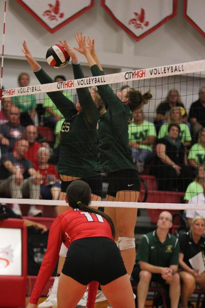 Colby Greene '18 and Emily Burtch '18 block the ball on Tuesday, Sept. 5. 