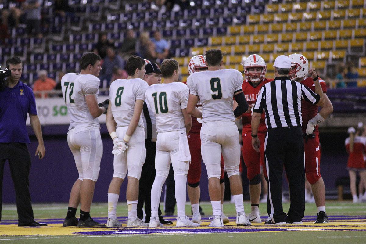 Captains Jonathan Gannon '18, Austin Geasland '18, Evan Flitz '18 and Dillon Doyle '18 go up for the coin flip for overtime on Friday, Sep. 8.