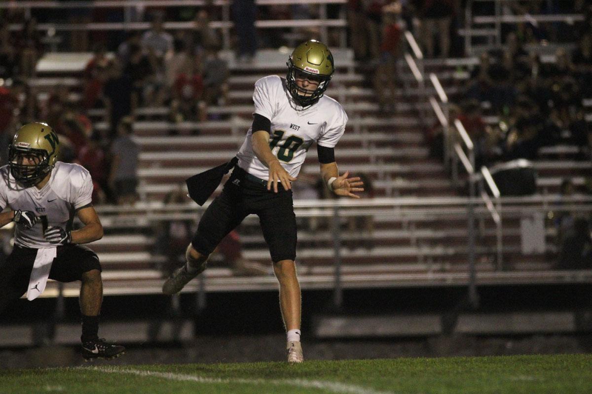 Evan Flitz '18 throws a pass down to field for a Trojan first down on Friday, Sep. 15.