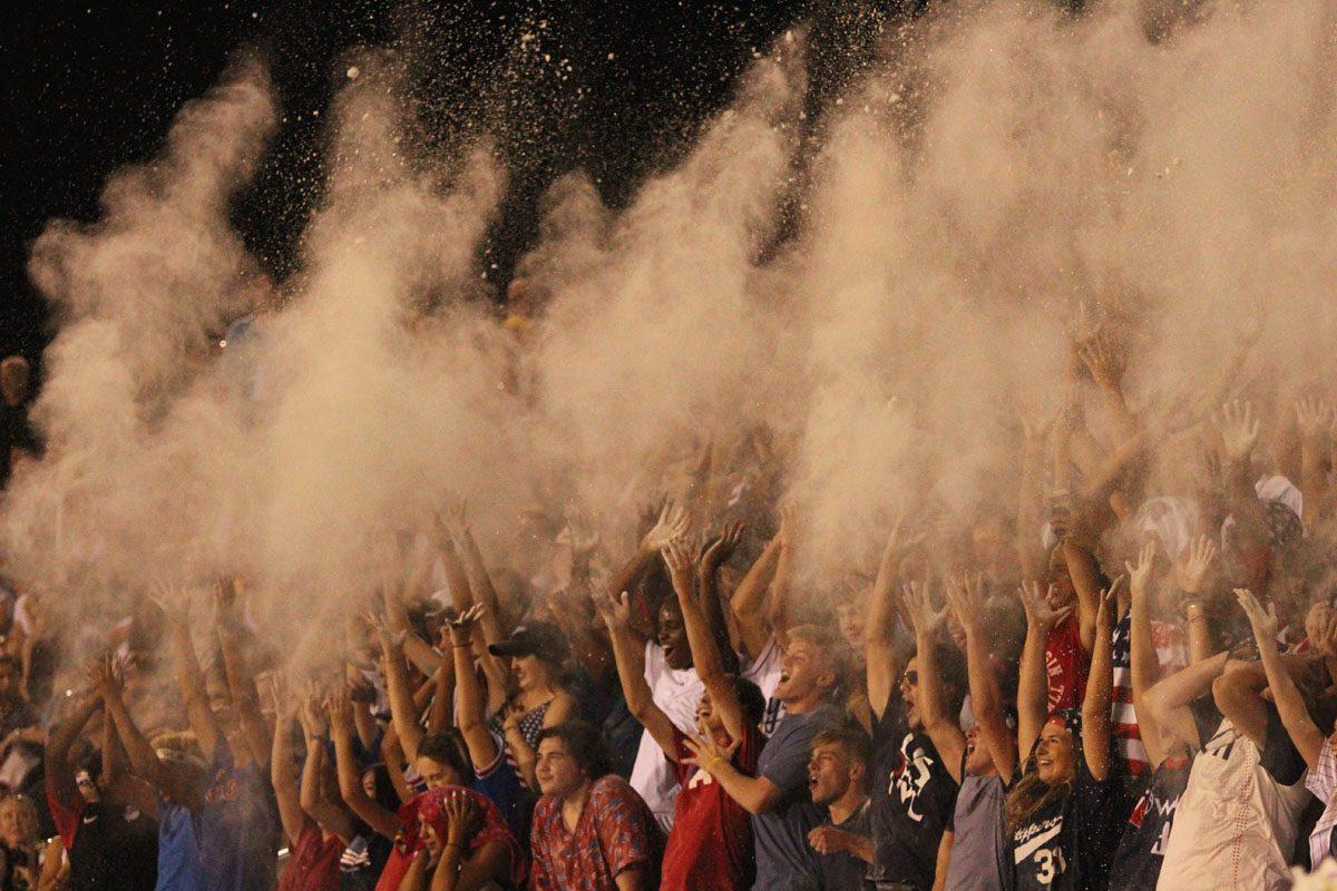 The student section throws flour in the air after the first kickoff.