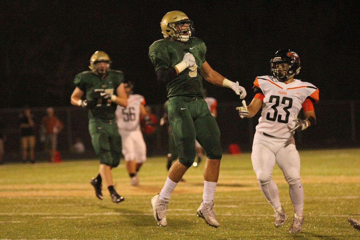 Dillon Doyle '18 celebrates after he deflected a pass, which forced Prairie to have a fourth down.