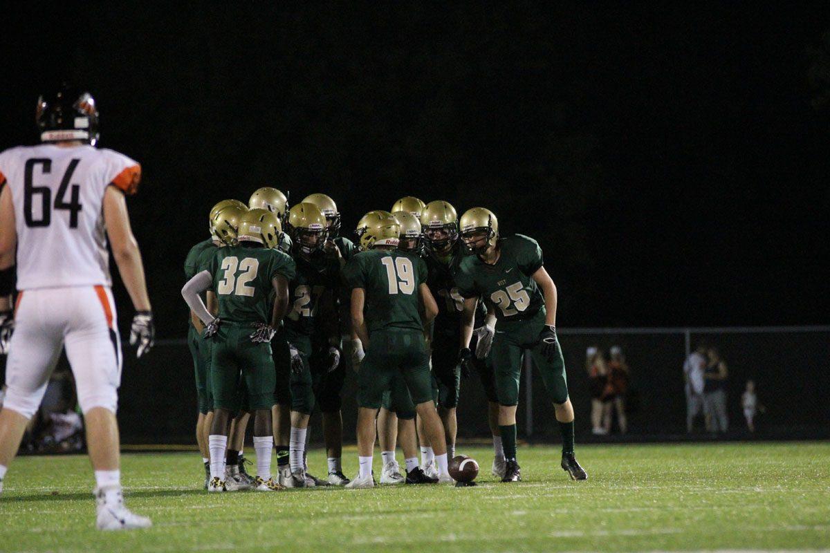 Lucas Karwal '18 talks to the kickoff team before a Trojan kickoff on Friday, Sep. 22.