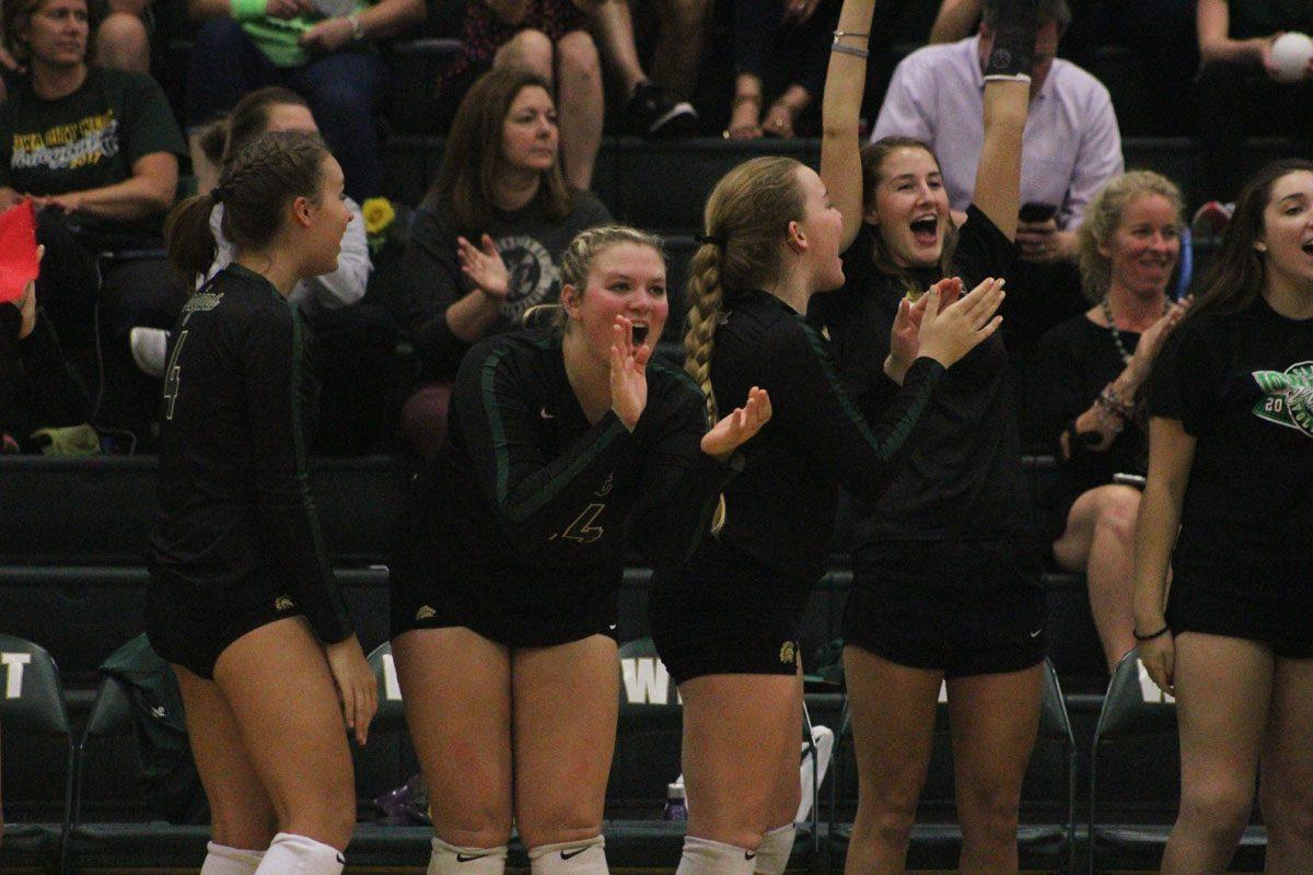 The team cheers as West takes the lead in the first set of the game on Tuesday, Sept. 26.