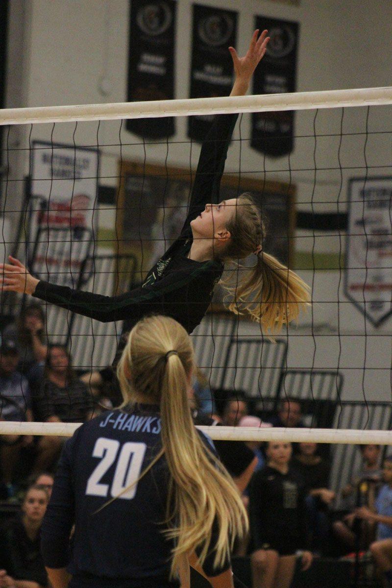 Claire Overton '19 jumps up to block the ball from coming over on Tuesday, Sept. 26. 