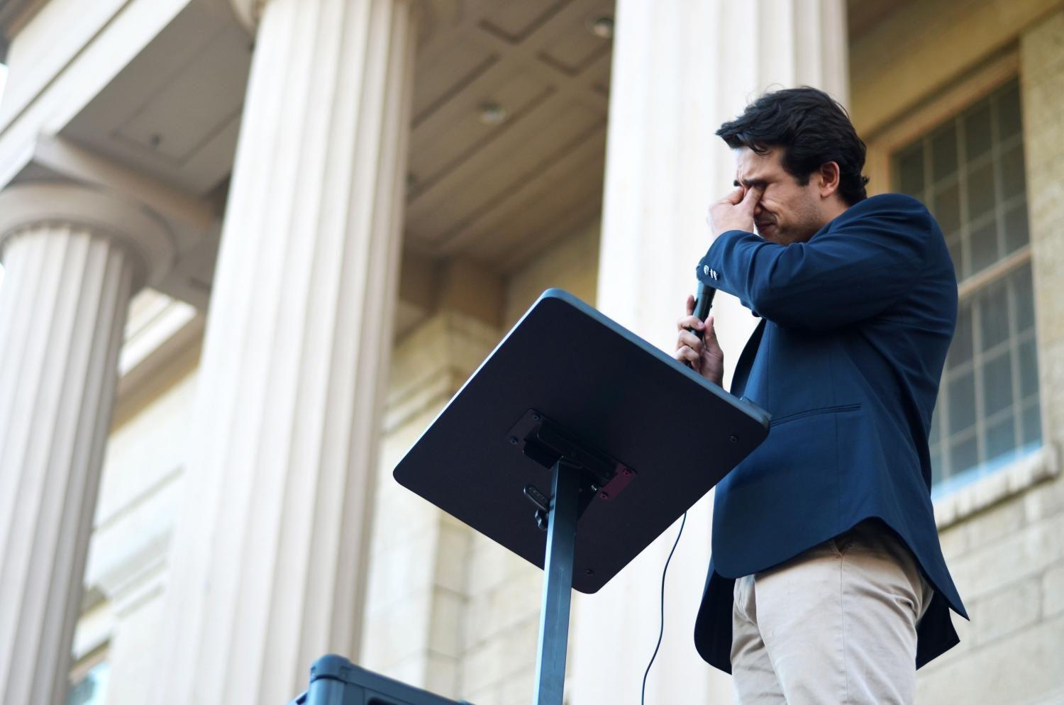 Protest organizer Emiliano Martinez gets emotional after a DACA recipient shares their story.