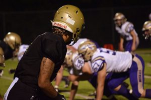 Traevis Buchanan 18 and the rest of the football team prepare for the play against Muscatine on Sep. 1. The scored ended up being 51-3. 