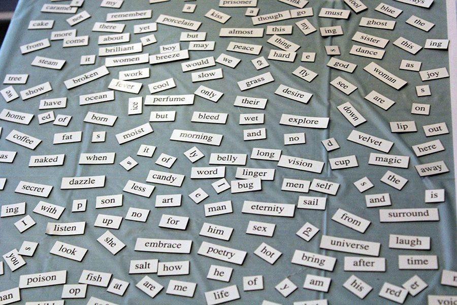Single word magnets lay out on the table for the American Writers Museum waiting for someone to string them together into a poem.