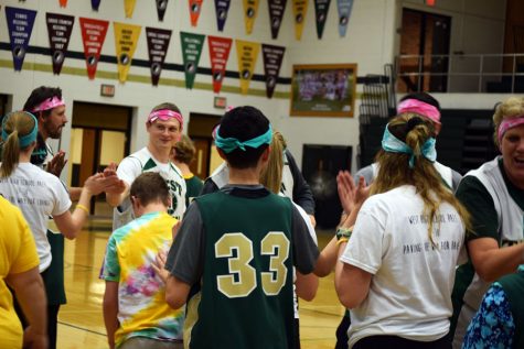 Best Buddies, PALs, and faculty high-five each other after the game. 