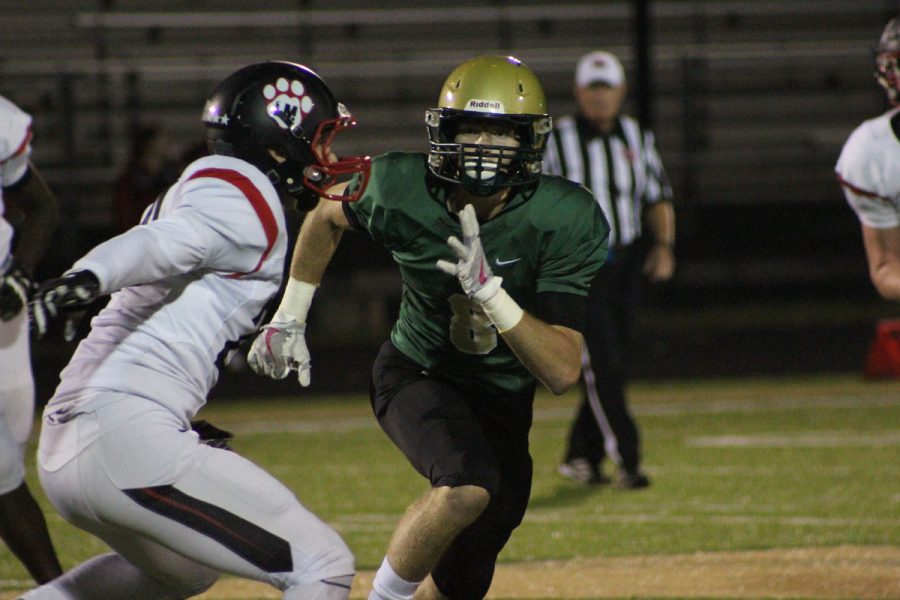 Austin Geasland '18 covers a Linn-Mar player on Friday, Oct. 13.