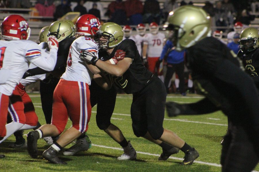 Jonathan Gannon '18 hits Washington's Jared Scherrman '18 on Friday, Oct. 27.