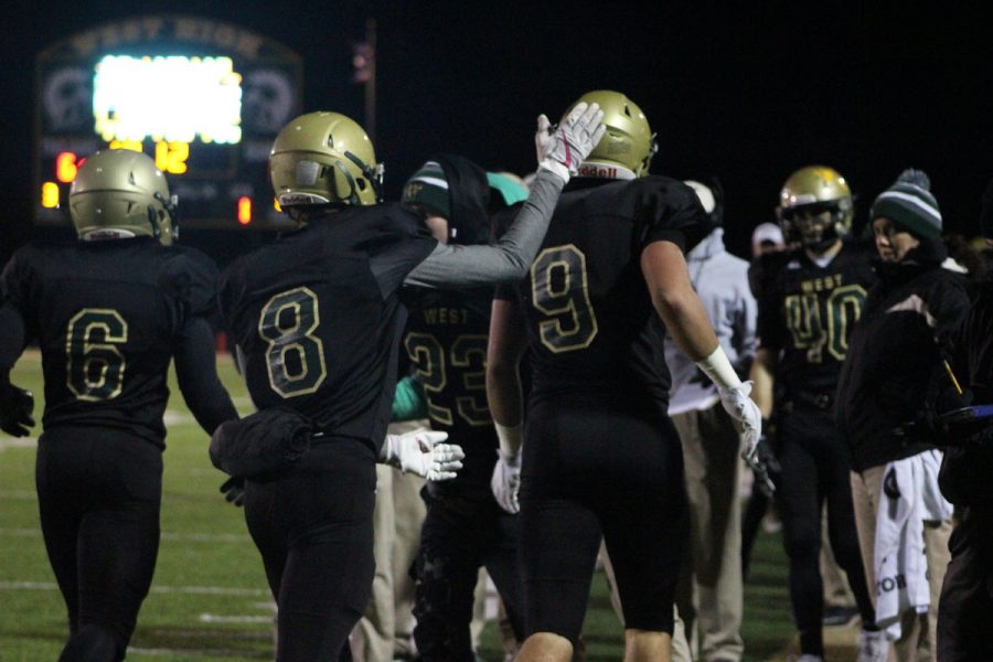 Austin Geasland '18 pats Dillon Doyle '18 on the head after Doyle scored the first touchdown of the game on Friday, Oct. 27.