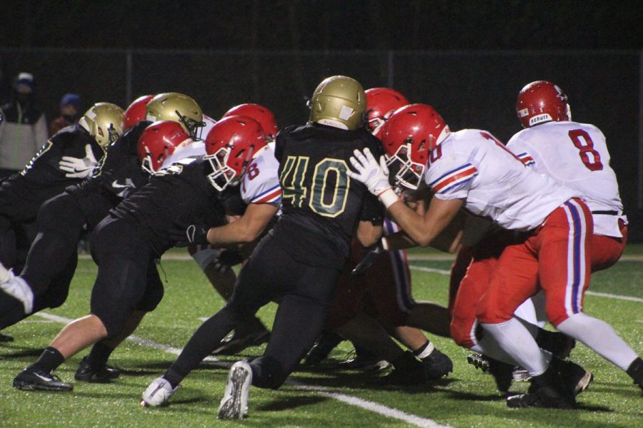 Dillon Shephard '18 blocks an offensive player from Washington on Friday, Oct. 27.