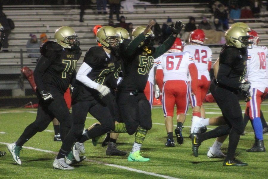 Guy Snow '18 throws his hands up in celebration after West won on Friday, Oct. 27.