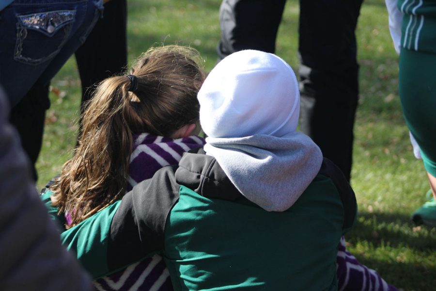 Claire Ronnebaum '18 comforts Erica Buettner '21 after the race. Buettner finished 74th with a time of 20:08 on Saturday, Oct. 28.