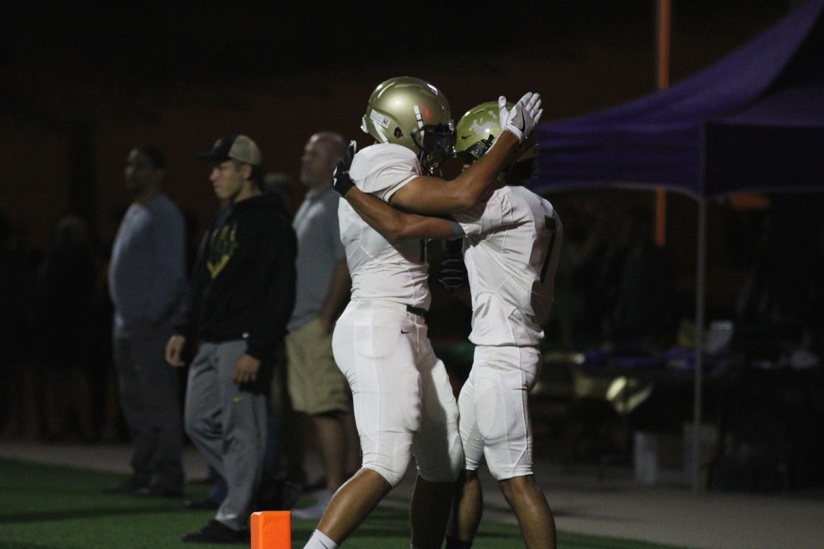 Jalen Gaudet '19 congratulates Traevis Buchanan '18 after Buchanan scored the first touchdown of the game on Friday, Sept. 29.