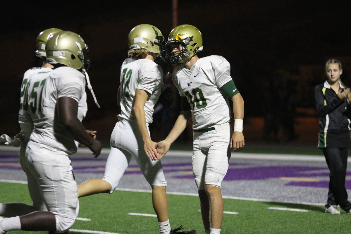 Captain Evan Flitz '18 high fives the rest of the team as they head to the locker room after their win on Friday, Sept. 29. 