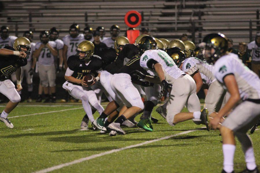 Evan Flitz '18 looks to hand off the ball to 	Owen McAreavy '19 on Friday, Oct. 6.