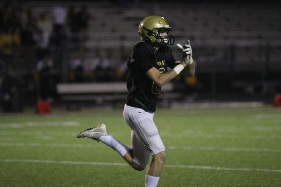 Austin Geasland '18 claps after he threw a touchdown to Evan Flitz '18 during a trick play on Friday, Oct. 6.