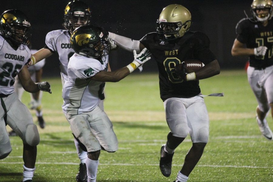 Trumell Roberts '18 stiff arms a Kennedy player on Friday, Oct. 6. 