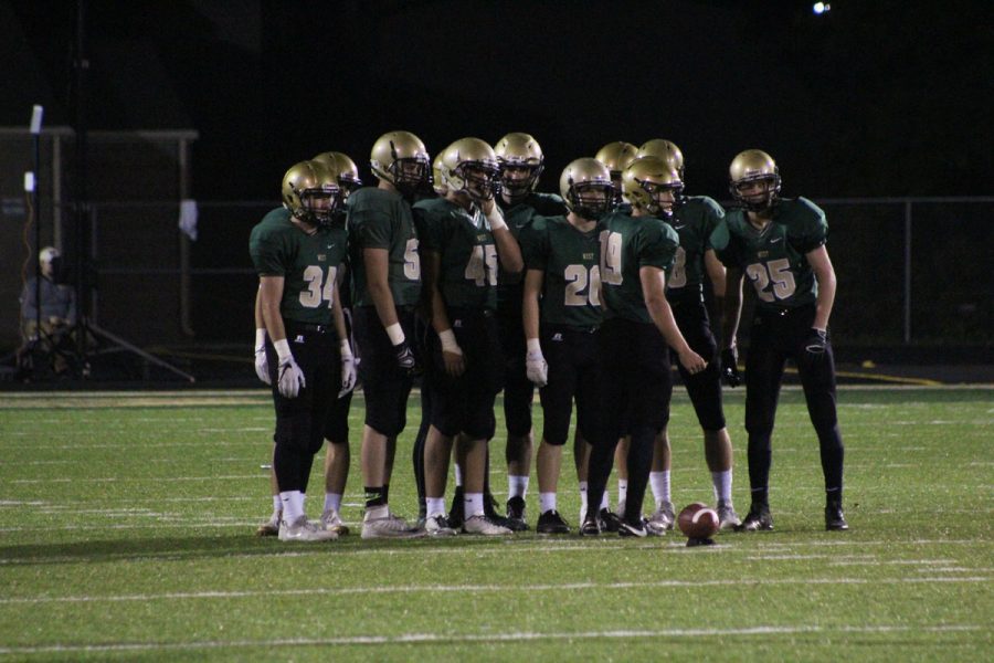 Lucas Karwal '18 talks to the special teams before a Trojan kickoff on Friday, Oct. 13.