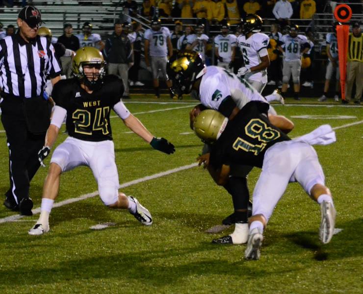 Cole Mabry 19 tackles a Kennedy player to stop them from gaining a first down.