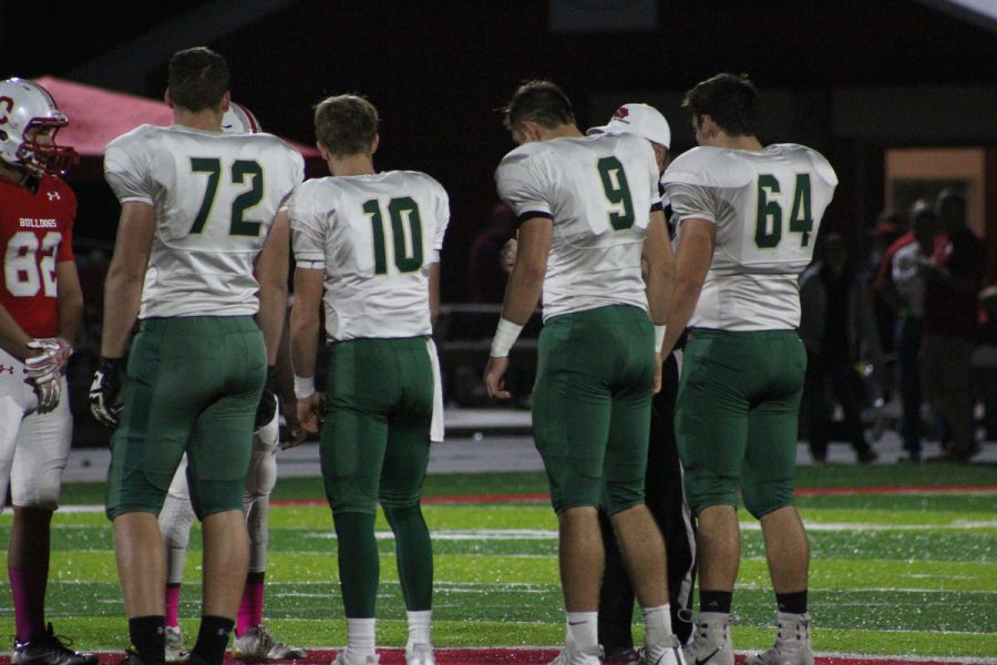 Captains Jonathan Gannon 18, Evan Flitz 18, Dillon Doyle 18 and Joe Briddle 18 go up for the coin toss on Friday, Oct. 20.