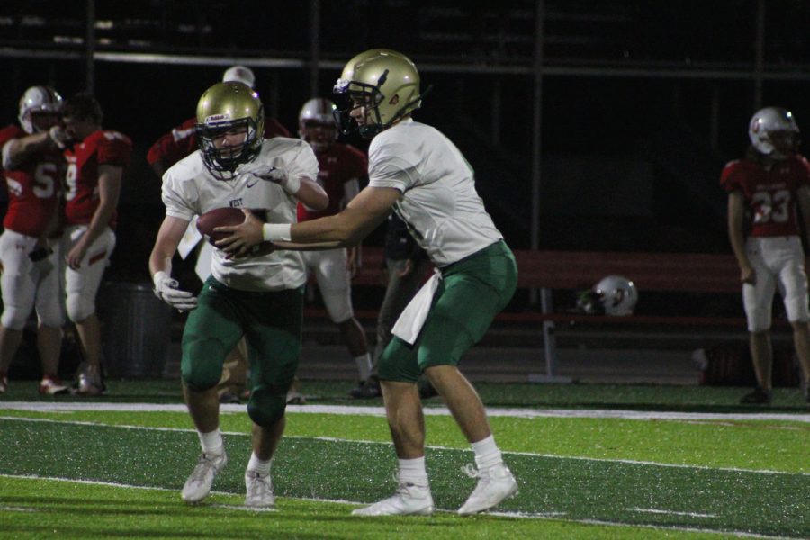 Joey Kuehn '19 hands the ball off to Peter Breitbach '19 on Friday, Oct. 20.