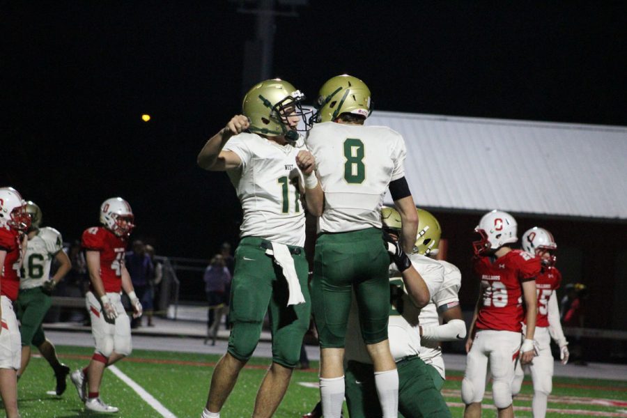 Joey Kuehn '19 celebrates with Austin Geasland '18 after he threw Geasland a touchdown pass on Friday, Oct. 20.