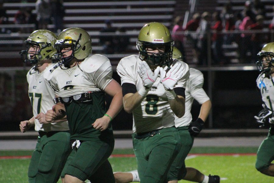 Austin Geasland '18 holds up a "W" after West beat Ottumwa 55-7 against on Friday, Oct. 20.