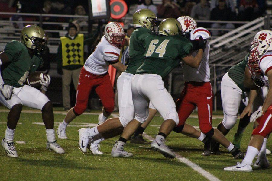 Dillon Doyle '18 and Joe Briddle '18 block a player from Cedar Falls on Friday, Nov. 3.