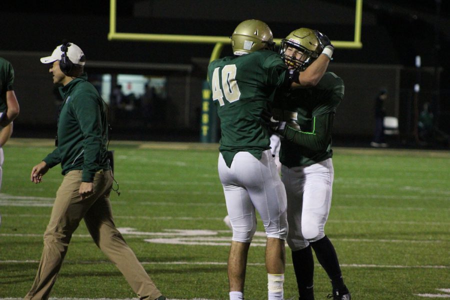 Dillon Shephard '18 and Quinn Baker '18 celebrate after the defense stopped Cedar Falls on a fourth down on Friday, Nov. 3.