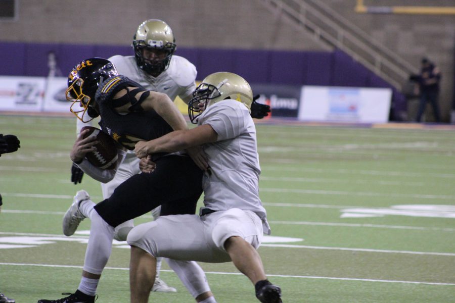 Landon Green '19 takes down a player from 		Bettendorf on Friday, Nov. 10.