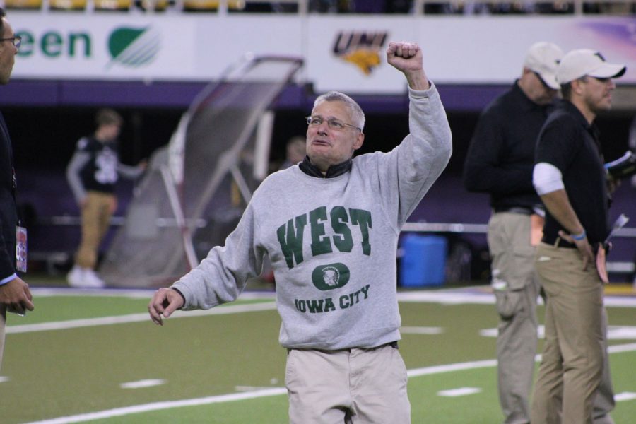 Mark "Brownie" Brown, long-time fan and supporter of West High, pumps his fist in the air after the Trojans won on Friday, Nov. 10. 