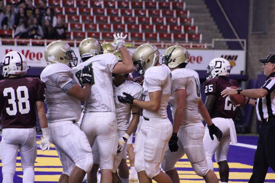 The offensive team congratulates Traevis Buchanan '18 after Buchanan scored the first touchdown of the game on Friday, Nov. 17.