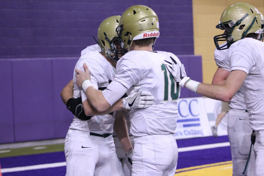 Evan Flitz '18 congratulates Austin West '18 after West scored a touchdown, making the score 35-21 Dowling on Friday, Nov. 17. 